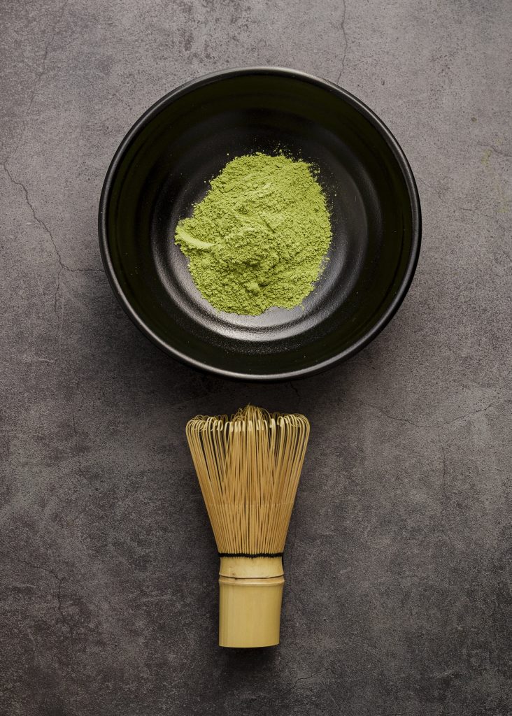 top-view-matcha-tea-powder-bowl-with-bamboo-whisk-min